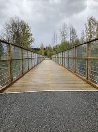 Empty footbridge against sky