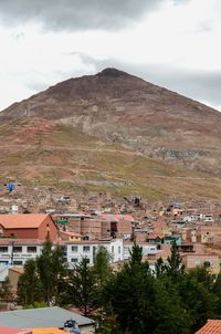 Residential buildings against cloudy sky