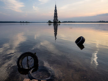 Mid distance view of kalyazin bell tower in volga river during sunset