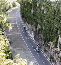 High angle view of men cycling on bicycle lane