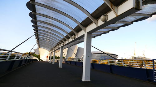 Bridge over road against sky in city