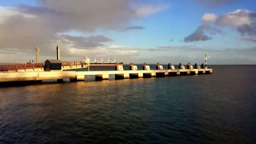 Scenic view of sea against cloudy sky