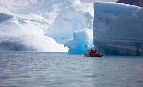 2 men traveling with a sea kayak in eastern greenland