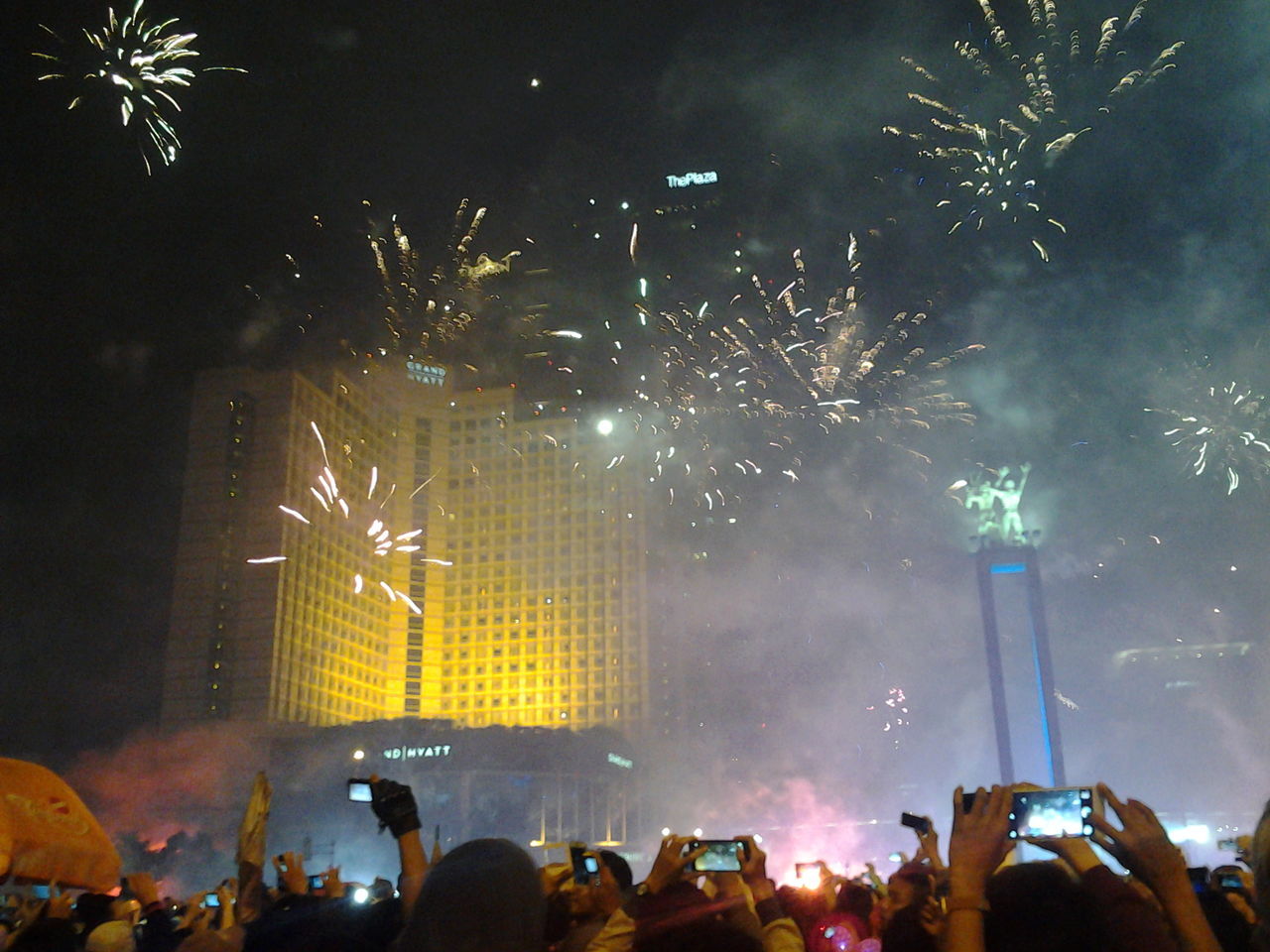 night, illuminated, long exposure, arts culture and entertainment, event, firework display, celebration, motion, firework, light - natural phenomenon, city, sky, large group of people, sparks, building exterior, exploding, firework - man made object, blurred motion, glowing