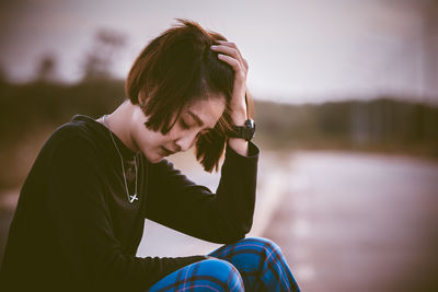 Portrait of woman sitting outdoors