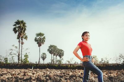 Portrait of smiling women standing on land against sky