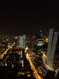 Aerial view of city lit up at night