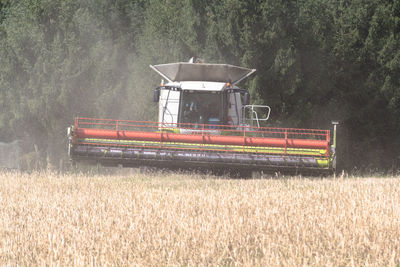 Combine harvester on farm field