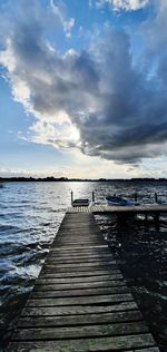 Pier over sea against sky