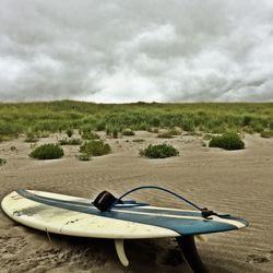 Boats in sea against cloudy sky