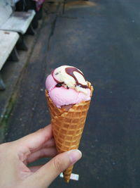 Cropped image of hand holding ice cream cone