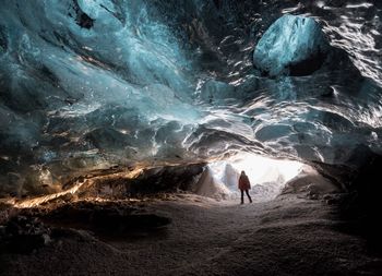 Woman walking in cave