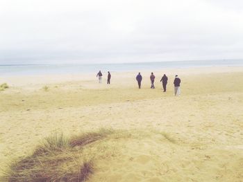 People on beach against sky