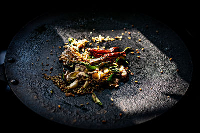 Indian spices being roasted on steel plate for cooking.