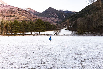 Person walking on snow covered mountain