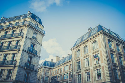 Low angle view of buildings against blue sky