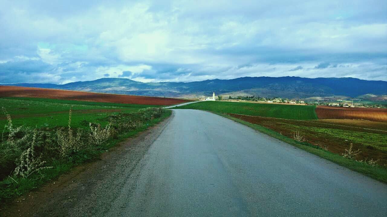 the way forward, sky, mountain, landscape, road, diminishing perspective, cloud - sky, country road, tranquil scene, vanishing point, tranquility, transportation, cloudy, mountain range, dirt road, scenics, cloud, field, nature, rural scene