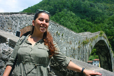 Caucasian tourist girl visiting the maddalena bridge in borgo a mozzano for the legend of the devil