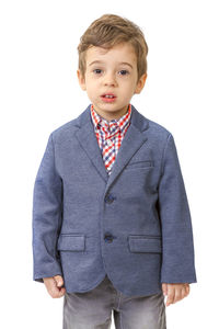 Portrait of boy standing against white background