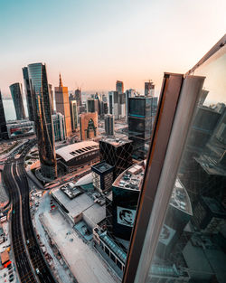 High angle view of buildings in city against sky during sunset