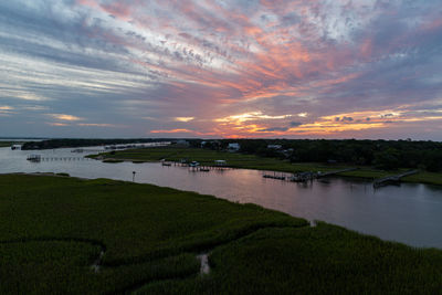Scenic view of lake against sky during sunset