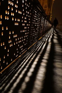 Shadow of illuminated electric lights on floor