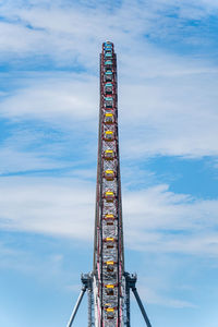 Side angle view of ferris wheel against sky