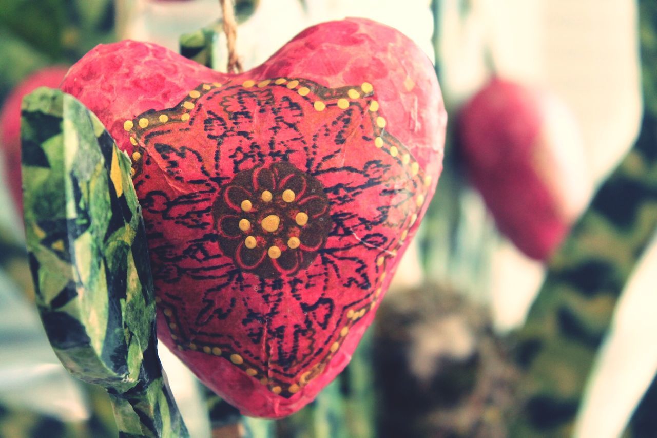 focus on foreground, close-up, red, freshness, selective focus, flower, growth, day, petal, fragility, hanging, nature, plant, no people, outdoors, rose - flower, leaf, decoration, beauty in nature, heart shape