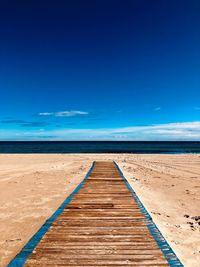 Scenic view of beach against blue sky