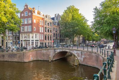 Bridge over canal amidst buildings in city