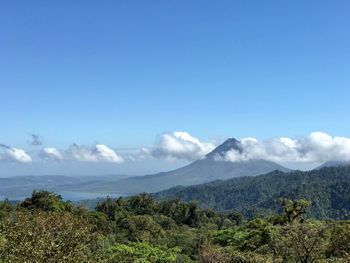 Scenic view of mountains against blue sky