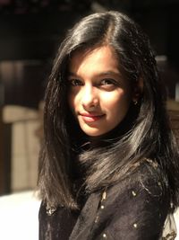 Close-up portrait of a smiling young woman