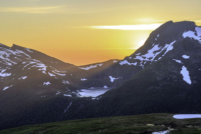 Scenic view of snowcapped mountains against sky during sunset