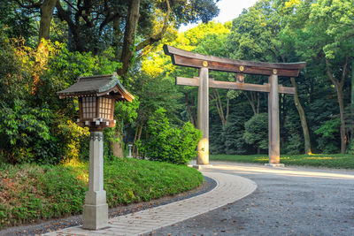 Gazebo in park against trees in forest