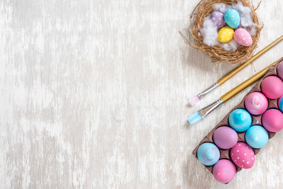 High angle view of multi colored eggs on table