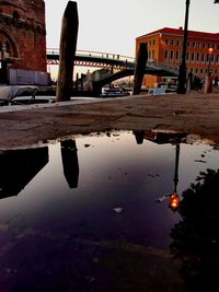 Reflection of buildings in river against sky