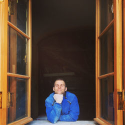 Portrait of young woman sitting in train