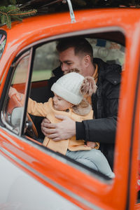 Portrait of smiling young woman in car