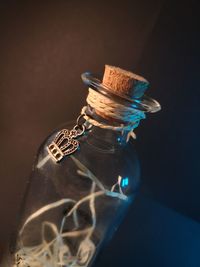 High angle view of glass bottle on table against black background