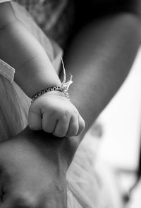 Cropped image of mother and child hand