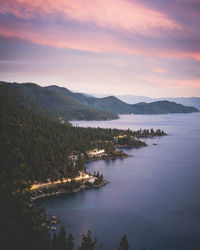 Cars driving along the shore of lake tahoe near incline village, nevada at sunset.