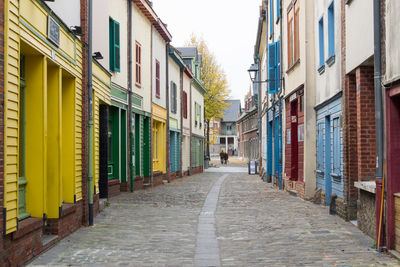 Empty narrow alley along buildings