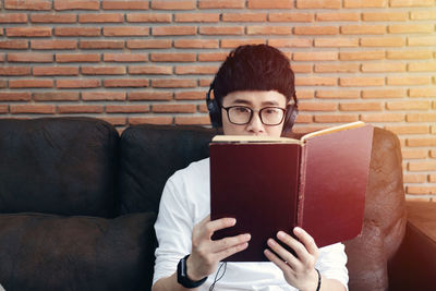 Portrait of young woman reading book