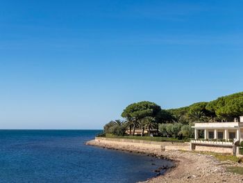 Scenic view of sea against clear blue sky