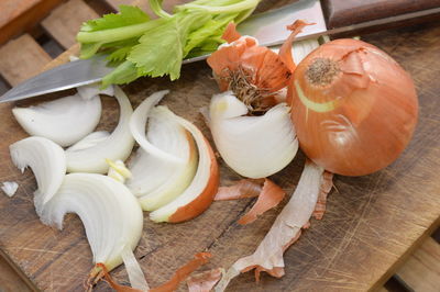 Close-up of vegetables with kitchen knife on cutting board