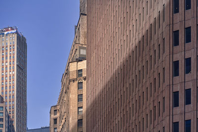 Low angle view of modern buildings against sky