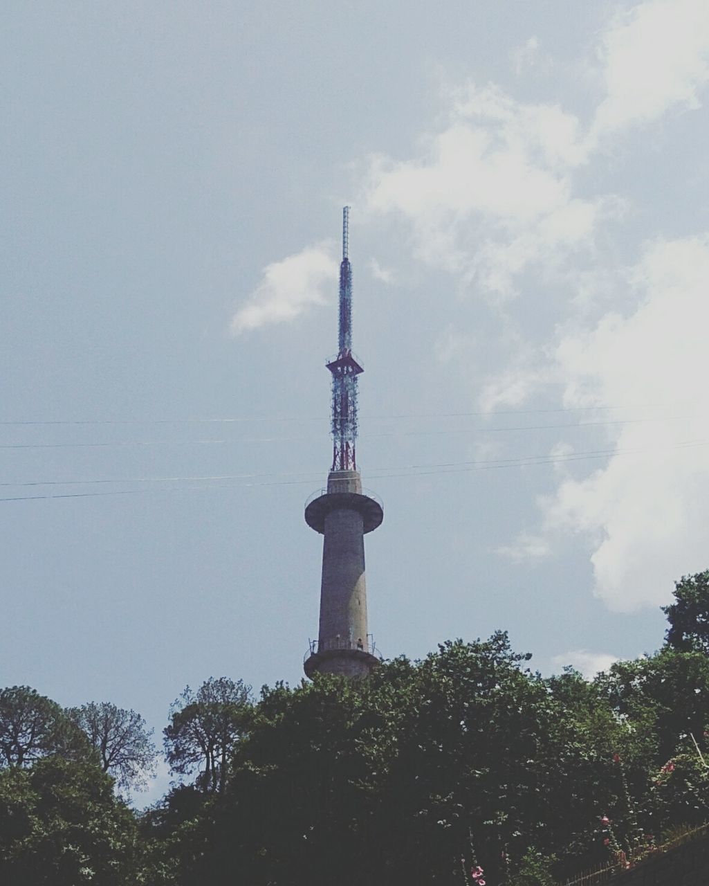 LOW ANGLE VIEW OF COMMUNICATIONS TOWER AGAINST SKY