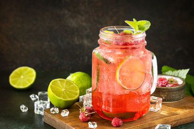 Various fruits in glass jar on table