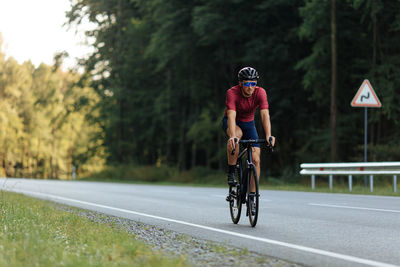 Man riding bicycle on road