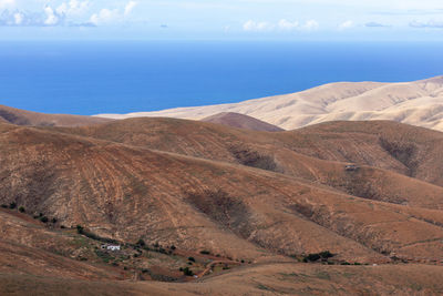 Scenic view of sea and mountains against sky